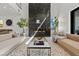 Modern living room features a marble fireplace, neutral-toned sofas and stylish decor accents at 82 Glade Hollow Dr, Las Vegas, NV 89135