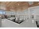 Large open loft area with wooden ceilings, modern railings, and bright white flooring at 82 Glade Hollow Dr, Las Vegas, NV 89135