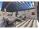 Outdoor kitchen and patio area features a built-in grill, bar seating, and comfortable lounge furniture at 82 Glade Hollow Dr, Las Vegas, NV 89135