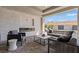 Covered patio with a fireplace, comfortable seating, and an outdoor living area at 82 Glade Hollow Dr, Las Vegas, NV 89135