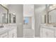 Dual vanities with white cabinets and framed mirrors in ensuite bathroom at 851 Klamath Springs St, Henderson, NV 89011