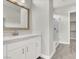 Bathroom featuring white cabinets, stone countertops, and a glass shower at 851 Klamath Springs St, Henderson, NV 89011