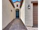 Covered entryway with a blue front door framed by stylish lanterns and brick walkway at 851 Klamath Springs St, Henderson, NV 89011