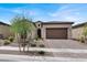 Charming single-story home featuring a tile roof, desert landscaping, and a two-car garage at 851 Klamath Springs St, Henderson, NV 89011