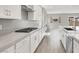 Bright kitchen featuring white cabinets, stainless steel appliances, and a stone countertop at 851 Klamath Springs St, Henderson, NV 89011