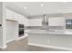 Modern kitchen featuring white cabinets, stainless steel appliances, and a center island at 851 Klamath Springs St, Henderson, NV 89011