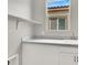 Bright laundry room features storage cabinets, modern countertops, and a sink at 851 Klamath Springs St, Henderson, NV 89011