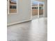Bright living room with sliding doors to the backyard, and gray tiled floors at 851 Klamath Springs St, Henderson, NV 89011
