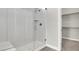Contemporary walk-in shower with white tile surround and chrome fixtures at 851 Klamath Springs St, Henderson, NV 89011