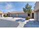 Inviting single-story home boasts a tile roof, mature tree, and a driveway leading to the two-car garage at 8524 Little Fox St, Las Vegas, NV 89123