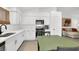 Bright kitchen with white cabinets, stainless appliances and a view to the living room at 8524 Little Fox St, Las Vegas, NV 89123