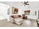 Living room boasts neutral colors, a ceiling fan, and wood-look floors at 8524 Little Fox St, Las Vegas, NV 89123