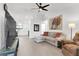 Bright living room features a ceiling fan, modern furniture, and wood-look flooring at 8524 Little Fox St, Las Vegas, NV 89123