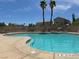 Inviting community pool area with palm trees, lounge chairs and clear, sparkling water at 8524 Little Fox St, Las Vegas, NV 89123