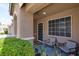 Inviting front porch with comfortable seating, desert landscaping, and an arched entry at 8524 Little Fox St, Las Vegas, NV 89123