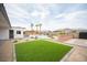 Spacious backyard showcasing a vibrant lawn, sparkling pool, and comfortable patio area at 8610 Mohawk St, Las Vegas, NV 89139