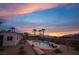 Backyard sunset view, boasting a sparkling pool, swaying palms, and comfortable lounge area at 8610 Mohawk St, Las Vegas, NV 89139
