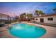An inviting backyard pool, complemented by patio furniture and lush landscaping at 8610 Mohawk St, Las Vegas, NV 89139