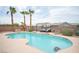 Sparkling in-ground pool features a seating area, mature palm trees, and outdoor furniture at 8610 Mohawk St, Las Vegas, NV 89139