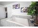 Bright bathroom features a luxurious soaking tub with stylish tile surround at 8610 Mohawk St, Las Vegas, NV 89139