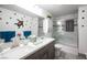 Bathroom with dual sinks, vanity, and a shower-tub combination at 8610 Mohawk St, Las Vegas, NV 89139