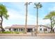 Inviting single-story home with manicured front yard, decorative wall, and mature palm trees at 8610 Mohawk St, Las Vegas, NV 89139