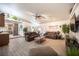 Open-concept living room featuring tile flooring, comfortable sofas, and seamless flow to kitchen at 8610 Mohawk St, Las Vegas, NV 89139