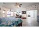 Airy main bedroom features ceiling fan, tile floors, seating, and large windows at 8610 Mohawk St, Las Vegas, NV 89139