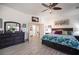 Open main bedroom offers gray tile floors, ceiling fan, and relaxing seating area at 8610 Mohawk St, Las Vegas, NV 89139