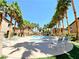 Inviting pool area with lounge chairs, palm trees, and community amenities at 8985 S Durango Dr # 1033, Las Vegas, NV 89113