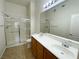 A clean and bright bathroom offering double sinks and a glass-enclosed shower at 8985 S Durango Dr # 1034, Las Vegas, NV 89113