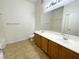 Well-lit bathroom features double sink vanity with updated fixtures and large mirror, alongside a shower and bath at 8985 S Durango Dr # 1034, Las Vegas, NV 89113