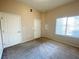 Neutral bedroom featuring carpet flooring, and two white doors for closet and bathroom access at 8985 S Durango Dr # 1034, Las Vegas, NV 89113