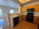 Galley style kitchen featuring wood cabinets and black appliances at 8985 S Durango Dr # 1034, Las Vegas, NV 89113