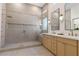 Elegant bathroom with double vanity, glass enclosed shower with rainfall shower head and custom tile at 921 Granger Farm Way, Las Vegas, NV 89145