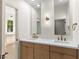 Bright bathroom featuring dual sinks with modern fixtures and a view into another room at 921 Granger Farm Way, Las Vegas, NV 89145