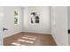 An empty room features wood floors, white walls, and bright windows ready to be turned into the perfect bedroom at 921 Granger Farm Way, Las Vegas, NV 89145