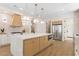 Bright and modern kitchen featuring a large island, stainless steel appliances, and wood-grain cabinetry at 921 Granger Farm Way, Las Vegas, NV 89145