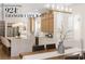 Bright kitchen with island seating, stainless appliances, and wood grain cabinets at 921 Granger Farm Way, Las Vegas, NV 89145