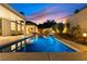 Inviting backyard pool and patio area with beautiful landscaping and sunset views at 921 Granger Farm Way, Las Vegas, NV 89145