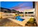 Spectacular pool and spa with a baja step, covered patio, and luxurious landscaping at 921 Granger Farm Way, Las Vegas, NV 89145