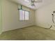 Comfortable bedroom featuring a ceiling fan and a window with shutter style blinds at 9524 Quail Ridge Dr, Las Vegas, NV 89134