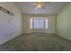 The main bedroom features a ceiling fan, carpet flooring and a large bay window with shutters at 9524 Quail Ridge Dr, Las Vegas, NV 89134