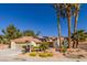 Inviting single-story home featuring desert landscaping and beautiful tall palm trees at 9524 Quail Ridge Dr, Las Vegas, NV 89134