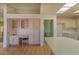 Eat-in kitchen featuring wood floors, office nook and open floorplan at 9524 Quail Ridge Dr, Las Vegas, NV 89134