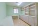 Home office features wood floors, a large desk and multiple cabinets with shelving for storage at 9524 Quail Ridge Dr, Las Vegas, NV 89134