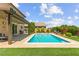 Inviting backyard featuring a sparkling pool, covered patio, and well-maintained landscaping at 9588 Vital Crest St, Las Vegas, NV 89123
