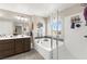 Bright bathroom features a soaking tub, glass-enclosed shower, and double vanity for added convenience at 9588 Vital Crest St, Las Vegas, NV 89123