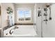 The bathroom features a large tub, glass enclosed shower, and views of the outside neighborhood at 9588 Vital Crest St, Las Vegas, NV 89123