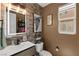 Stylish half-bathroom with unique wall decor, modern lighting, and neutral tones at 9588 Vital Crest St, Las Vegas, NV 89123